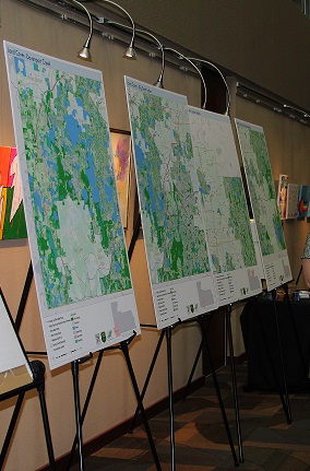 Several maps are on display on easels